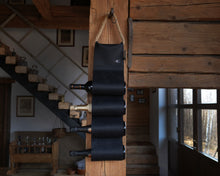 Load image into Gallery viewer, Handmade black leather wine bottle holder with a space for multiple bottles, displayed alongside a tissue box cover and additional leather pieces.