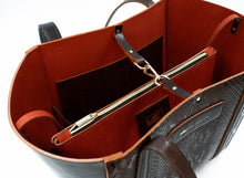 Load image into Gallery viewer, Close-up of a brown leather bag with a gold zipper on a white background