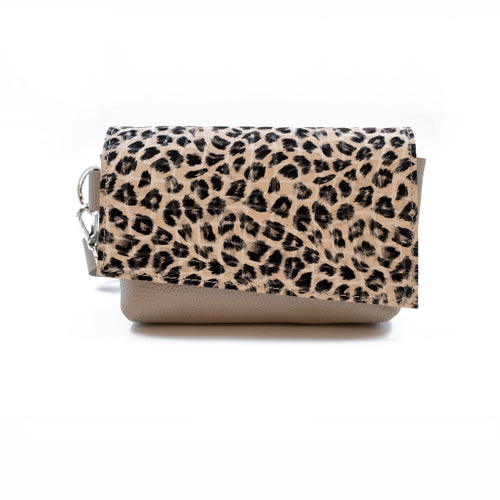 Handbag with leopard print top section and beige bottom section on a white background